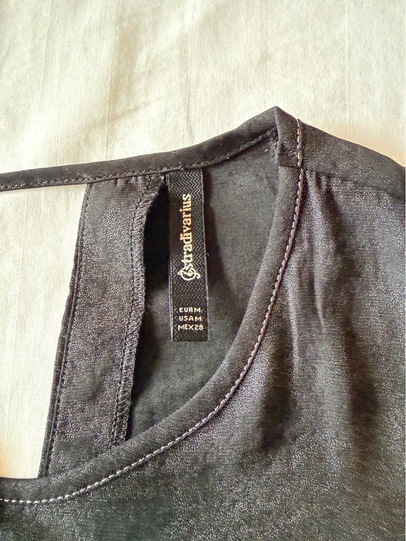 Stradivarius Metallic Dark Grey Sleeveless Top (Category: Sleeveless) located in Muntinlupa City. Submitted by mmivs (Listing ID 1456473825, Image 3). Description: Brand: Stradivarius Size: US Medium - Sleeveless flowy design - Round neckline - Loose fit - Metallic dark grey lightweight material RFS: decluttering.