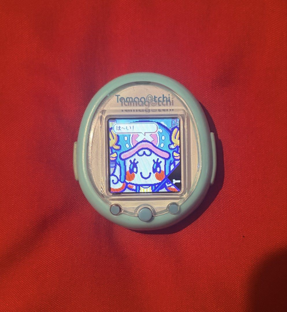 Tamagotchi Smart Mint (PLEASE READ DESCRIPTION FIRST) (Category: Interactive Toys) located in Cavite. Submitted by tamavee.jacs (Listing ID 1456515514, Image 2). Description: Please read description first Tamagotchi smart mint With one piece anime downloaded smartcard Japanese language Issue tanggal na yung cover sa charging port (see picture) nababalik naman may onting discoloration see pic Then sa pag charge may tamang pwesto ng charging siya. 