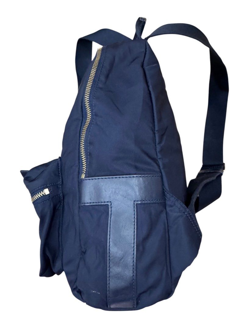 Tory Burch Tilda Nylon Zip Backpack (Category: Luxury Bags & Wallets) located in San Fernando. Submitted by northerncloset330 (Listing ID 1456551151, Image 2). Description: This Tory Burch Tilda Backpack combines lightweight functionality with polished designer style. Crafted from durable, easy-to-clean navy blue nylon, it features signature gold-tone zippers that add a refined contrast. The front is detailed with a subtle, color-matched stacked-