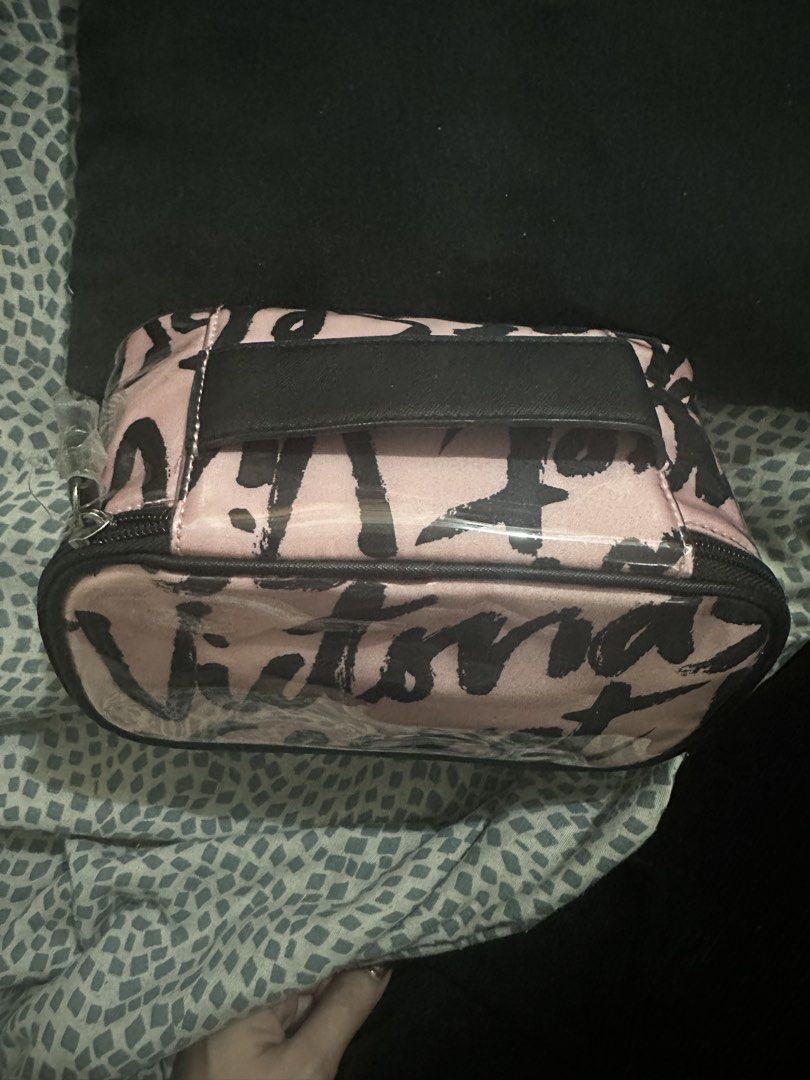 VS makeup pouch- travel case (Category: Makeup) located in Manila. Submitted by rarejap808 (Listing ID 1456532861, Image 2). Description: 100% Authentic, purchased directly from a Victoria’s Secret store in Dubai. Signature pink and black brushstroke print with the iconic “Victoria’s Secret” logo design. ✨ Details: • Like new condition — barely used • Clean interior, no stains or odor • Fully functional zipper • Great for makeup, toiletries, or a