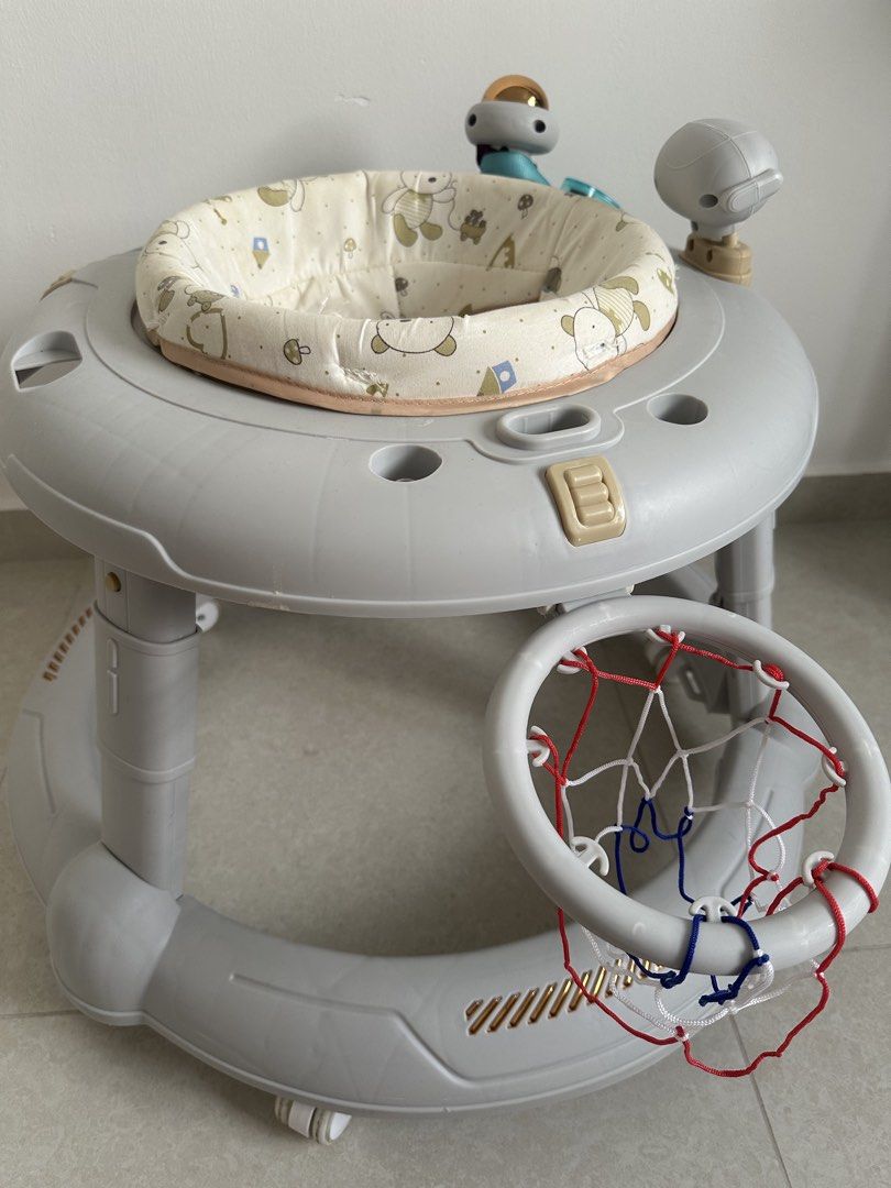 Walker (Category: Infant Playtime) located in Singapore. Submitted by auntiepeh (Listing ID 1456426562, Image 3). Description: - Baby walker designed to aid first steps - Features interactive toys for entertainment - Padded seat with a cute animal print - Includes a mini basketball hoop attachment - Self-collection available at Blk 206C Compassvale Lane.