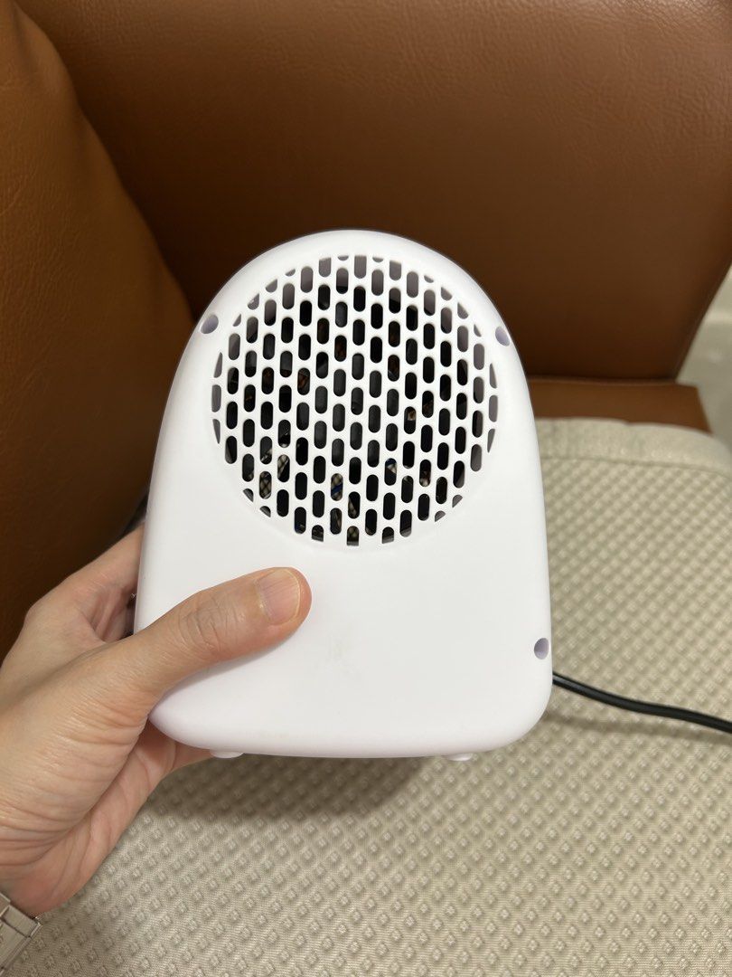 White Portable Electric Heater with Fan (Category: Fans) located in Manila. Submitted by raynebow (Listing ID 1456430535, Image 2). Description: - Compact electric heater, ideal for personal space. - Simple on/off switch for easy operation. - Features a European type plug. - Small and lightweight for easy portability. - Perfect for heating a desk area or small room. - Provides quick and efficient warmth..