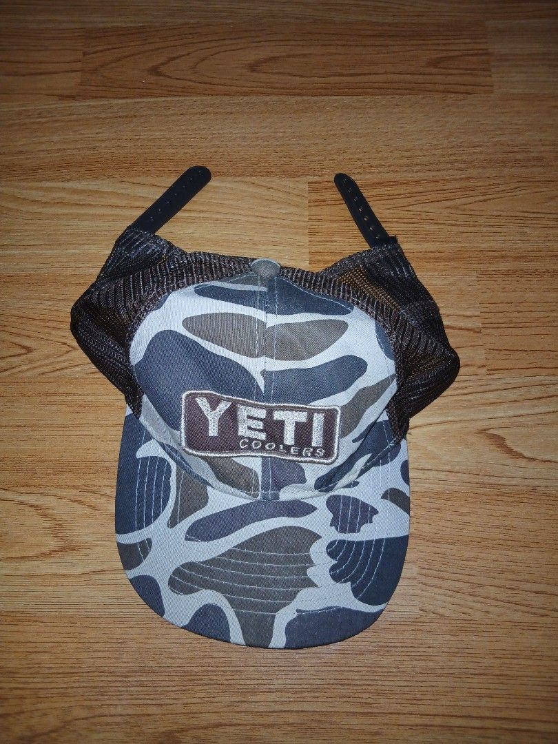 Yeti Coolers Camo Trucker Hat (Category: Caps & Hats) located in General Santos City (Dadiangas). Submitted by afsph1996 (Listing ID 1456525297, Image 1). Description: - Yeti Coolers trucker hat - Camouflage pattern on front and brim - Breathable mesh back - Adjustable snapback closure - Interior band features "Wildly Stronger! Keep Ice Longer! YETI COOLERS" - Ideal for outdoor adventures.