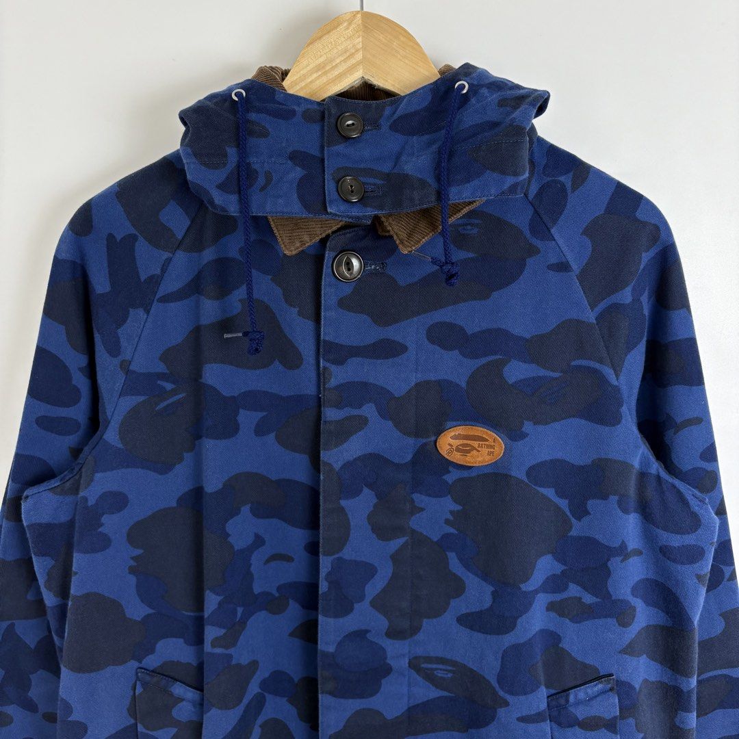A Bathing Ape Blue Camo Fishtail Parka Jacket (Category: Coats, Jackets and Outerwear) located in Calamba. Submitted by 2muchclothes_ (Listing ID 1453368531, Image 3). Description: Measurements Size: Medium Width: 22.5 Length: 30.5 Neckline: 10 Sleeve to Neckline: 27 Materials: 100% Cotton & Cowhide Leather Made In: Japan Buttons: *A Bathing Ape Condition: 9/10 Flaws: Signs of usage -Removable Hood.