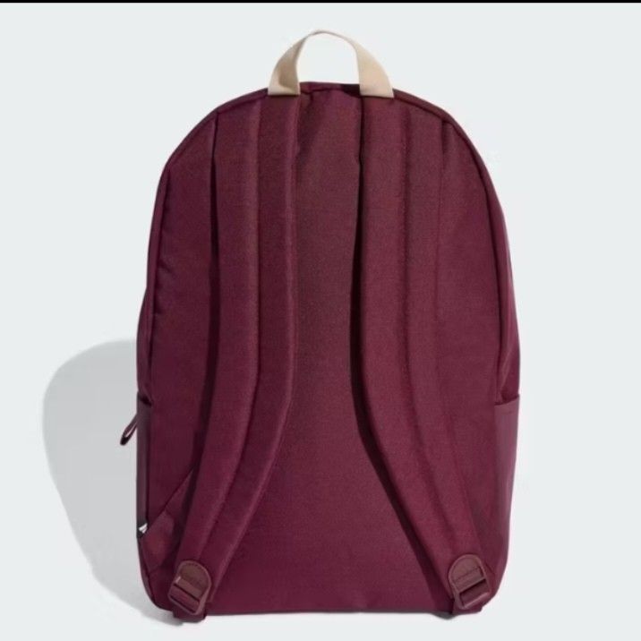 Adidas Burgundy Backpack 27.4L - 3 Bar Logo (Category: Backpacks) located in Valenzuela. Submitted by jc120505 (Listing ID 1453346793, Image 3). Description: - Stylish burgundy Adidas backpack with prominent 3 Bar Logo. - Spacious main compartment with wide opening - Features 3 Bar Logo tape across the front zip pocket. - Comfortable padded and adjustable shoulder straps. - Generous 27.4L volume. - Dimensions: 15 cm (width) x 31 cm (depth) x 44 c