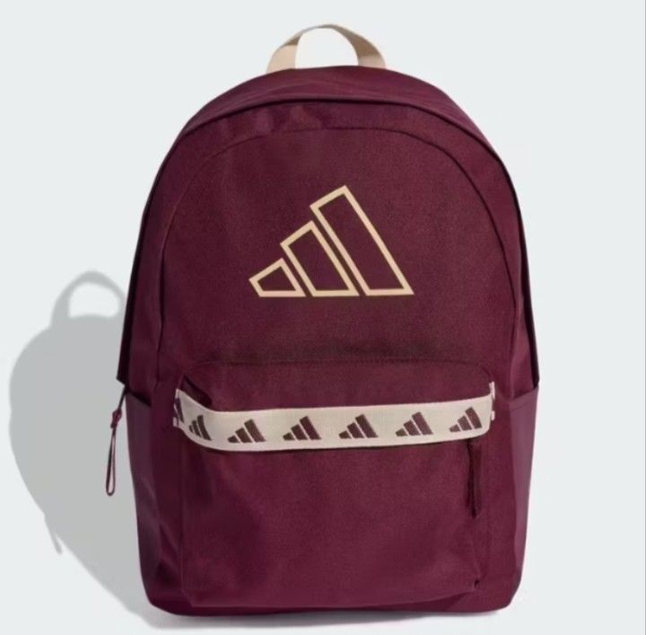 Adidas Burgundy Backpack 27.4L - 3 Bar Logo (Category: Backpacks) located in Valenzuela. Submitted by jc120505 (Listing ID 1453346793, Image 1). Description: - Stylish burgundy Adidas backpack with prominent 3 Bar Logo. - Spacious main compartment with wide opening - Features 3 Bar Logo tape across the front zip pocket. - Comfortable padded and adjustable shoulder straps. - Generous 27.4L volume. - Dimensions: 15 cm (width) x 31 cm (depth) x 44 c