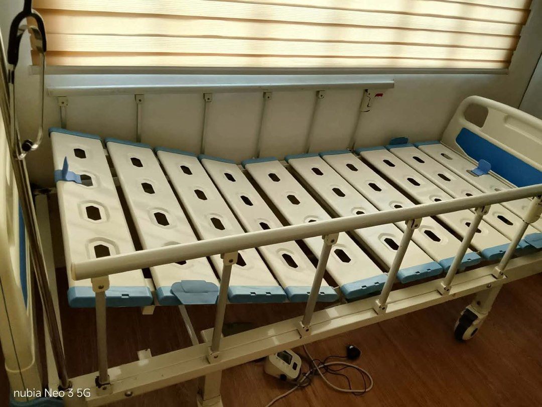 Adjustable Hospital Bed with Crank (Category: Medical Supplies & Tools) located in Rizal. Submitted by ramarosita969 (Listing ID 1453409726, Image 2). Description: - Adjustable hospital bed with manual cranks - Backrest and leg positions can be adjusted - Sturdy bed frame with safety side rails - Wheels for easy mobility - Includes an oxygen tank holder - Perfect for home healthcare needs - free medical oxygen regulator.