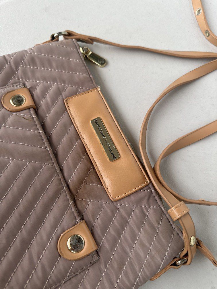 Adrienne Vittadini Crossbody Bag (Category: Cross-body Bags) located in Manila. Submitted by classywardrobemanila (Listing ID 1453295018, Image 2). Description: Adrienne Vittadini Taupe/Gray quilted crossbody Purse w/outside pocket. Top closure is zipper. Great, preowned condition. Bag width: 10inches Material: Quilted polyester/nylon. Features: Adjustable crossbody strap, front pocket with snap closures, and interior pockets. As this is a used i