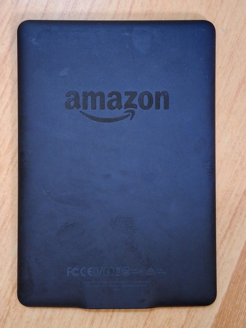 Amazon Kindle E-reader - Black (Category: E-Readers) located in Taguig. Submitted by dani1115 (Listing ID 1453247330, Image 2). Description: - Black Amazon Kindle e-reader - Shows a low battery icon on screen - Features Amazon logo on the back - Power button and charging port visible on the side - Ideal for reading books on the go RFS: Hindi nagagamit Bilhan nyo na lang charger.