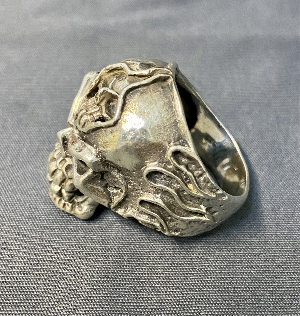 Authentic Custom 925 Silver Skull Ring with Flame Details (Category: Jewelry) located in Iloilo. Submitted by mrstrauss (Listing ID 1453369647, Image 3). Description: -Size 9.5 - Unique skull ring with intricate detailing. - Features cool flame accents on the sides. - A perfect statement piece to elevate any outfit. - Stand out with this one-of-a-kind design..