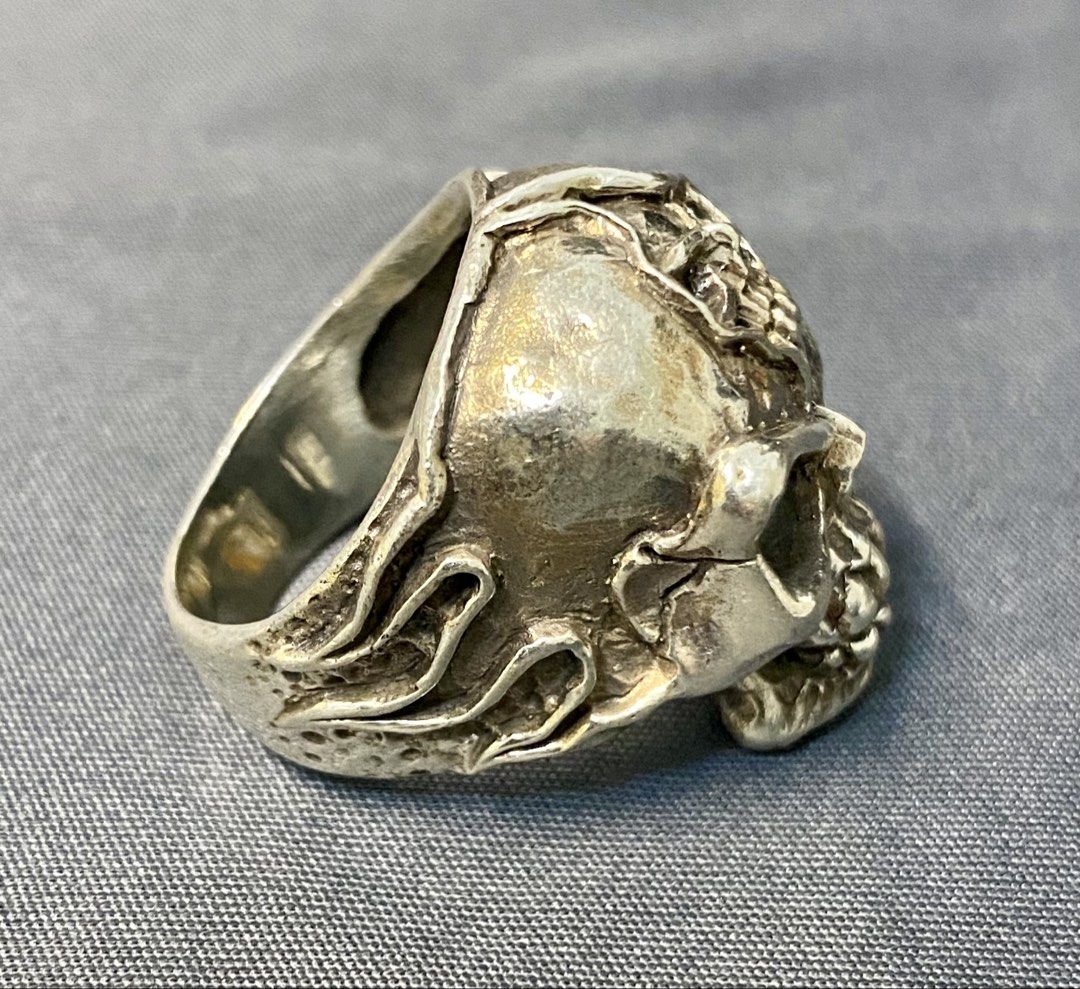 Authentic Custom 925 Silver Skull Ring with Flame Details (Category: Jewelry) located in Iloilo. Submitted by mrstrauss (Listing ID 1453369647, Image 2). Description: -Size 9.5 - Unique skull ring with intricate detailing. - Features cool flame accents on the sides. - A perfect statement piece to elevate any outfit. - Stand out with this one-of-a-kind design..