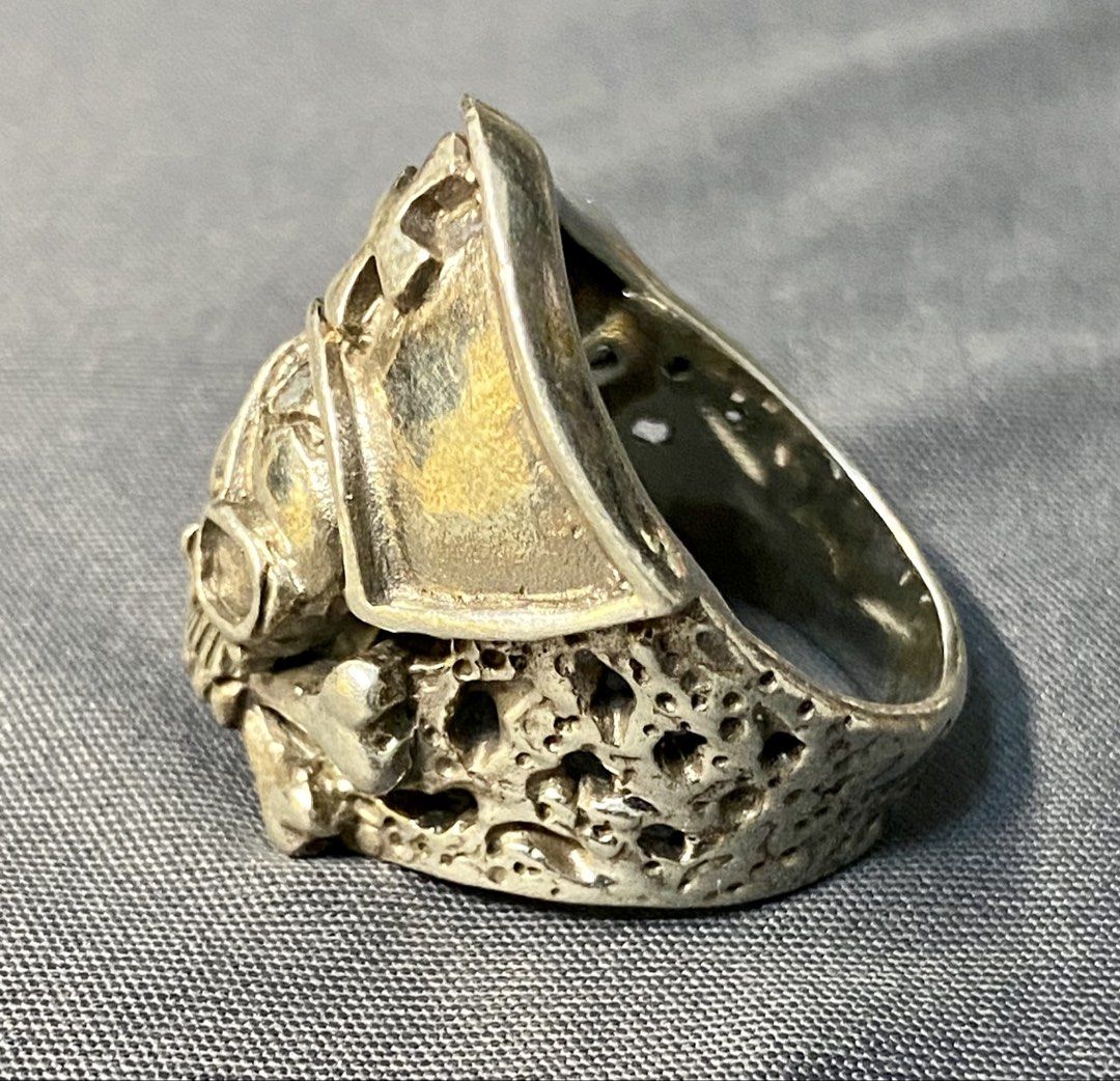 Authentic Custom Silver 925 Pirate Skull Ring with Cross and Eyepatch (Category: Jewelry) located in Iloilo. Submitted by mrstrauss (Listing ID 1453371043, Image 3). Description: -Size 8.5 - Cool pirate skull ring - Made of genuine 925 silver - Features a cross on the hat and an eyepatch - Textured, porous band design - Unique statement piece.