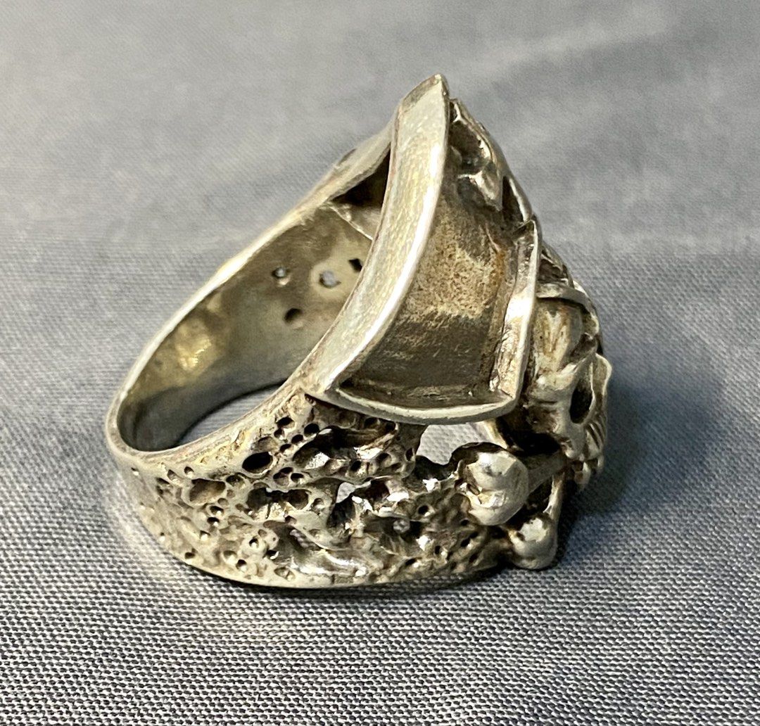 Authentic Custom Silver 925 Pirate Skull Ring with Cross and Eyepatch (Category: Jewelry) located in Iloilo. Submitted by mrstrauss (Listing ID 1453371043, Image 2). Description: -Size 8.5 - Cool pirate skull ring - Made of genuine 925 silver - Features a cross on the hat and an eyepatch - Textured, porous band design - Unique statement piece.