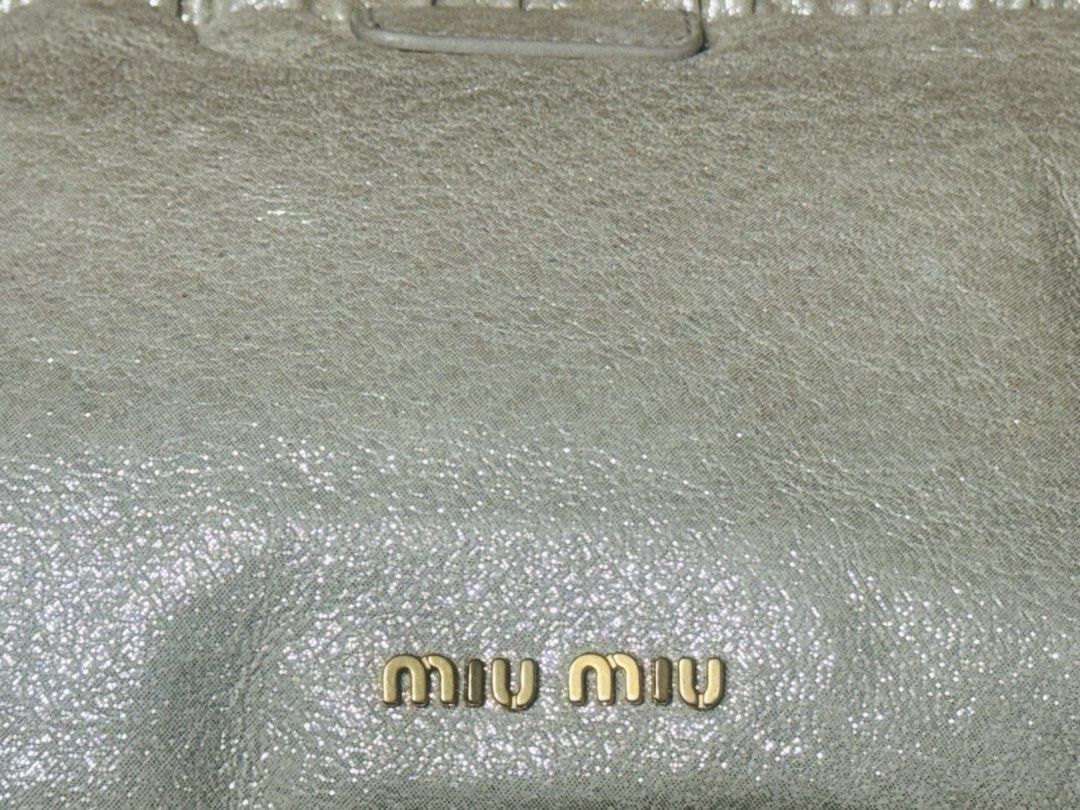 [AUTHENTIC] Miu Miu Leather Pouch Clutch Bag (Category: Luxury Bags & Wallets) located in Santa Rosa. Submitted by rjaarmblo (Listing ID 1453380272, Image 2). Description: - Miu Miu pouch in a light, shimmery neutral color - Genuine leather with a gathered top - Iconic gold Miu Miu logo on the front - Interior features a gold plaque: 'Miu Miu Made in Italy' - Ideal for organizing your daily essentials -Can be used from day to night -Guaranteed au