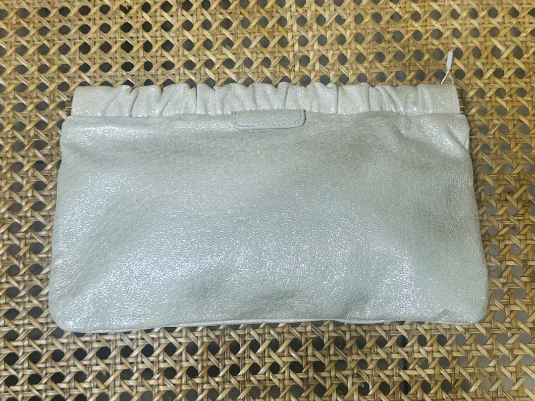 [AUTHENTIC] Miu Miu Leather Pouch Clutch Bag (Category: Luxury Bags & Wallets) located in Santa Rosa. Submitted by rjaarmblo (Listing ID 1453380272, Image 3). Description: - Miu Miu pouch in a light, shimmery neutral color - Genuine leather with a gathered top - Iconic gold Miu Miu logo on the front - Interior features a gold plaque: 'Miu Miu Made in Italy' - Ideal for organizing your daily essentials -Can be used from day to night -Guaranteed au