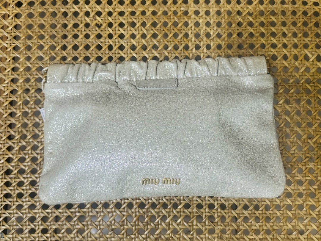 [AUTHENTIC] Miu Miu Leather Pouch Clutch Bag (Category: Luxury Bags & Wallets) located in Santa Rosa. Submitted by rjaarmblo (Listing ID 1453380272, Image 1). Description: - Miu Miu pouch in a light, shimmery neutral color - Genuine leather with a gathered top - Iconic gold Miu Miu logo on the front - Interior features a gold plaque: 'Miu Miu Made in Italy' - Ideal for organizing your daily essentials -Can be used from day to night -Guaranteed au