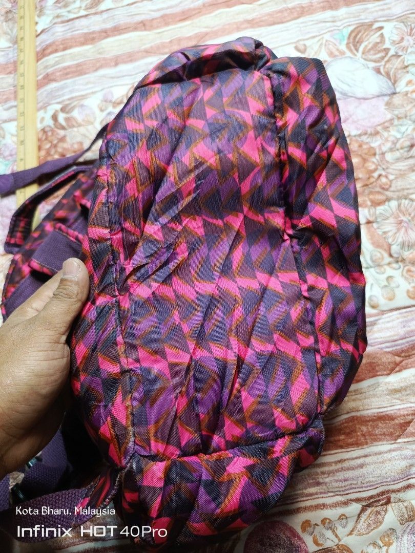 Backpack Kipling (Category: Backpacks) located in Kuala Lumpur. Submitted by grandturtle_dd5ca3 (Listing ID 1453422943, Image 3). Description: Brand: Kipling. Model: Similar to the City Pack line. Color/Pattern: Pink and Burgundy geometric pattern. Features: Features a main compartment and multiple zippered pockets.