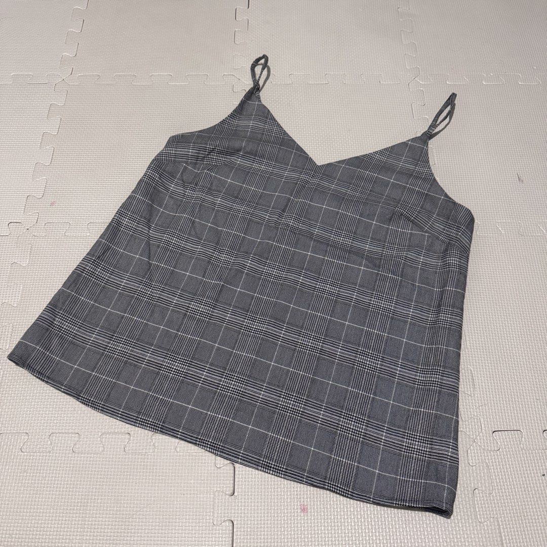 Banana Republic Plaid Cami Top S/P (Category: Sleeveless) located in Marikina City. Submitted by prelovedsms (Listing ID 1453311949, Image 1). Description: - Grey plaid cami top - Brand: Banana Republic - Features adjustable straps - Black trim along neckline - Chest measurement: approx. 16 inches - Versatile for layering or wearing alone Big sizing.