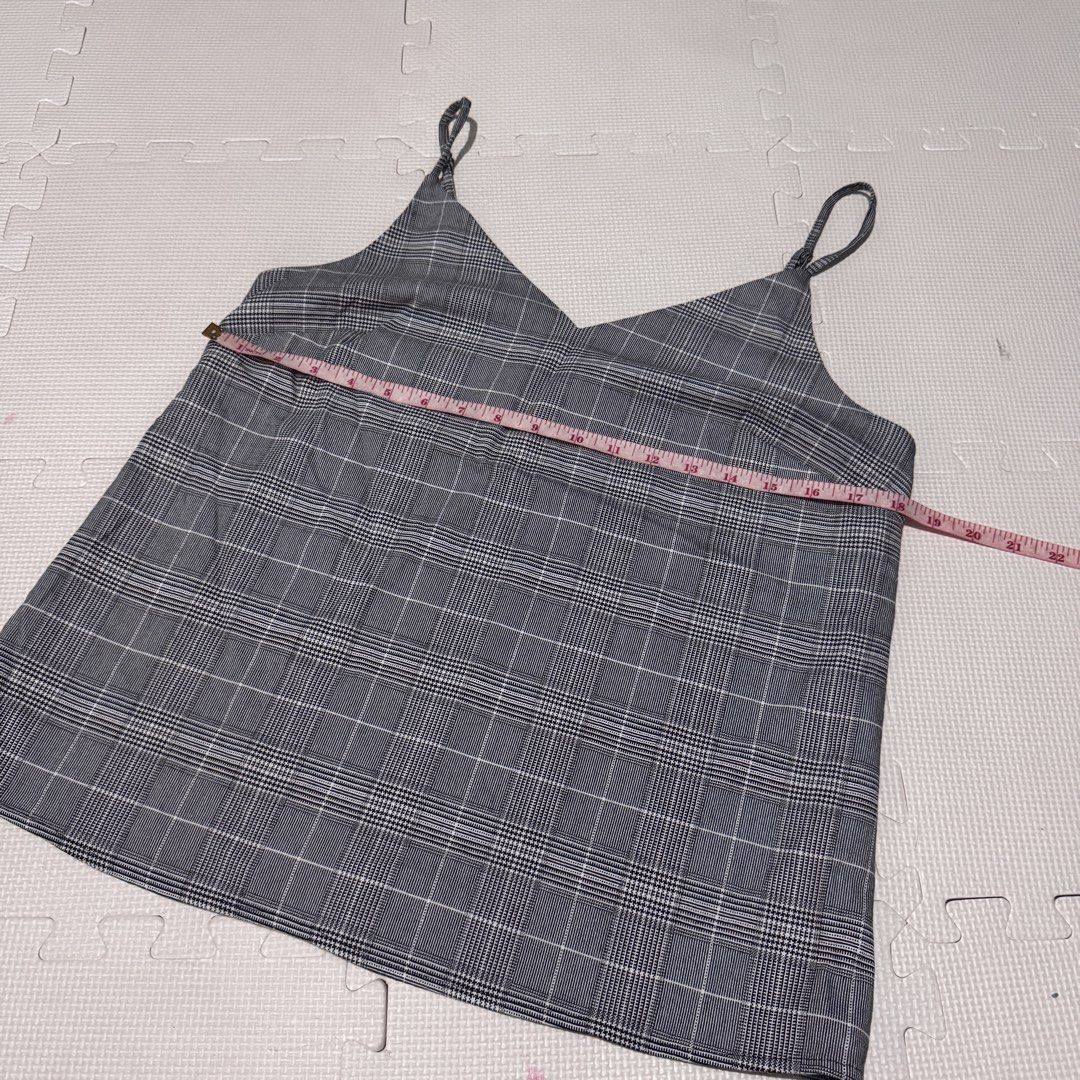 Banana Republic Plaid Cami Top S/P (Category: Sleeveless) located in Marikina City. Submitted by prelovedsms (Listing ID 1453311949, Image 2). Description: - Grey plaid cami top - Brand: Banana Republic - Features adjustable straps - Black trim along neckline - Chest measurement: approx. 16 inches - Versatile for layering or wearing alone Big sizing.