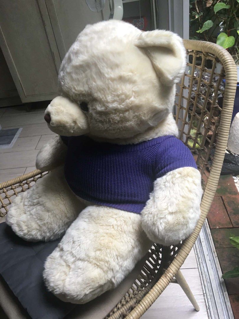 Bear Cuddler Teddy Bear with Purple Sweater (Category: Plushies & Soft Toys) located in Quezon City. Submitted by ronster (Listing ID 1453288306, Image 3). Description: - Adorable cream-colored teddy bear - Features a cozy knitted purple sweater - Sweater tag reads 'Bear Cuddler' - Very soft and huggable texture - Ideal for decoration or as a thoughtful gift - Looking for a loving new home!.