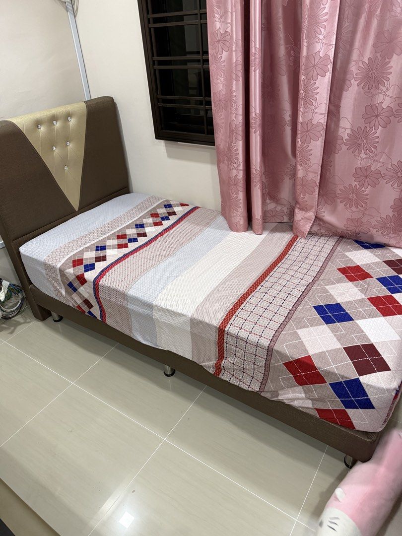 Bed frames (Category: Bed Frames & Mattresses) located in Singapore. Submitted by breakthelight (Listing ID 1453380473, Image 2). Description: Single bed frame. Beige/brown upholstery with tufted headboard. Sturdy platform base. Both for $50.