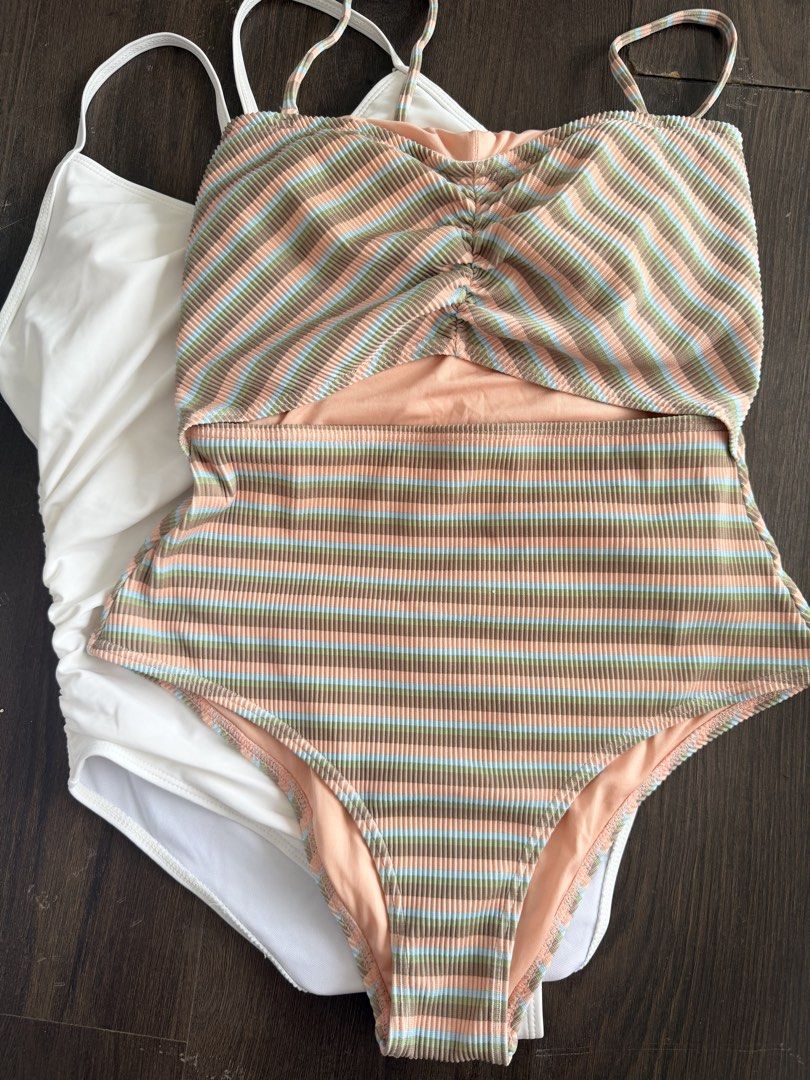Billabong Striped & White One-Piece Swimsuits (Category: Bikinis & Swimsuits) located in Manila. Submitted by _tala_17 (Listing ID 1453235721, Image 2). Description: - Two one-piece swimsuits, both size 12 (US). - White swimsuit with flattering ruched sides. - Colorful striped Billabong swimsuit featuring a stylish cutout and gold hardware. - Ideal for your next beach vacation or pool day. - Comfortable and fashionable choices..