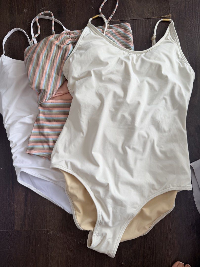 Billabong Striped & White One-Piece Swimsuits (Category: Bikinis & Swimsuits) located in Manila. Submitted by _tala_17 (Listing ID 1453235721, Image 1). Description: - Two one-piece swimsuits, both size 12 (US). - White swimsuit with flattering ruched sides. - Colorful striped Billabong swimsuit featuring a stylish cutout and gold hardware. - Ideal for your next beach vacation or pool day. - Comfortable and fashionable choices..