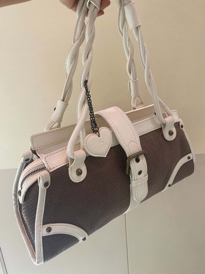 Burberry Blue Label Shoulder Bag (Category: Luxury Bags & Wallets) located in Manila. Submitted by luxblocc (Listing ID 1453270743, Image 3). Description: - Authentic Burberry Blue Label tote bag - Stylish brown and white color combination - Features unique twisted white leather handles - Adorned with a charming heart logo charm - Decorative buckle detail on the front - Secure zipper closure - Ideal for everyday errands and activities.