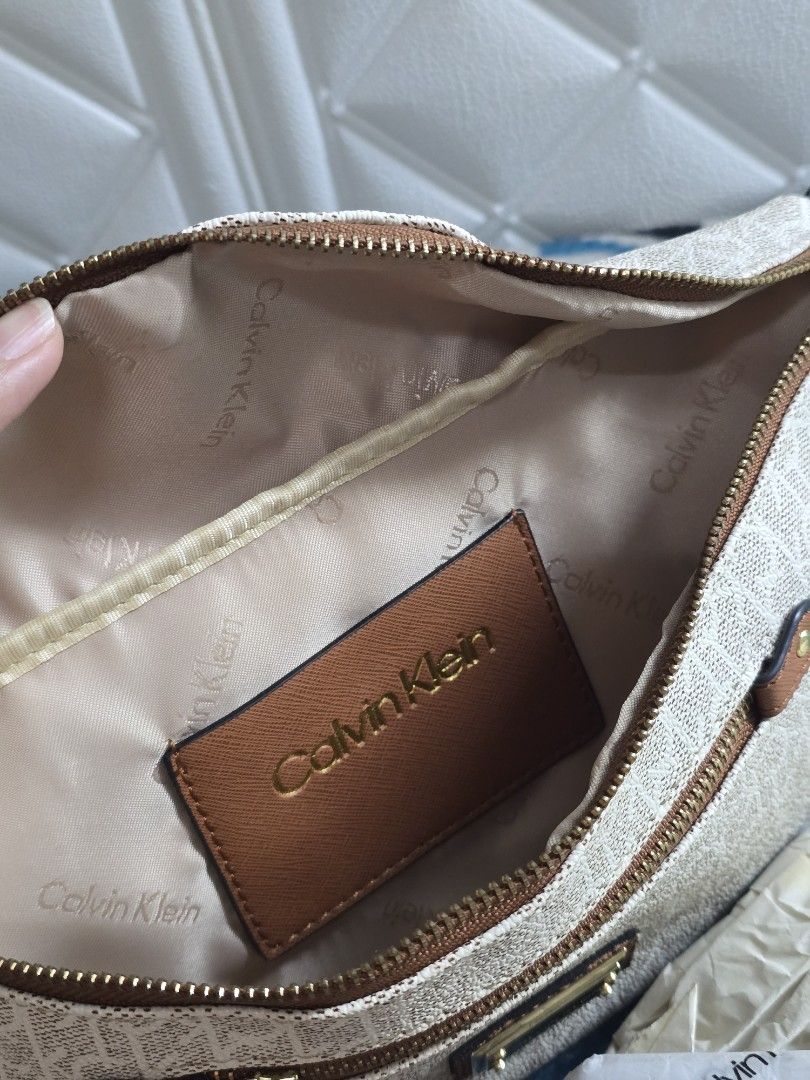Calvin Klein Monogram Belt Bag Fanny Pack (Category: Luxury Bags & Wallets) located in Manila. Submitted by trialfindsmanila (Listing ID 1453414613, Image 3). Description: Barely used Very good condition slightly nego‼️‼️ Rfs: Declutter Delivery via Lalamove or Pick Up Location: Sta. Ana Manila - Authentic White Calvin Klein Belt Bag - All-over CK Monogram Print - Elegant Gold Hardware - Stylish Brown Trim Accents - Adjustable Strap with Calvin K