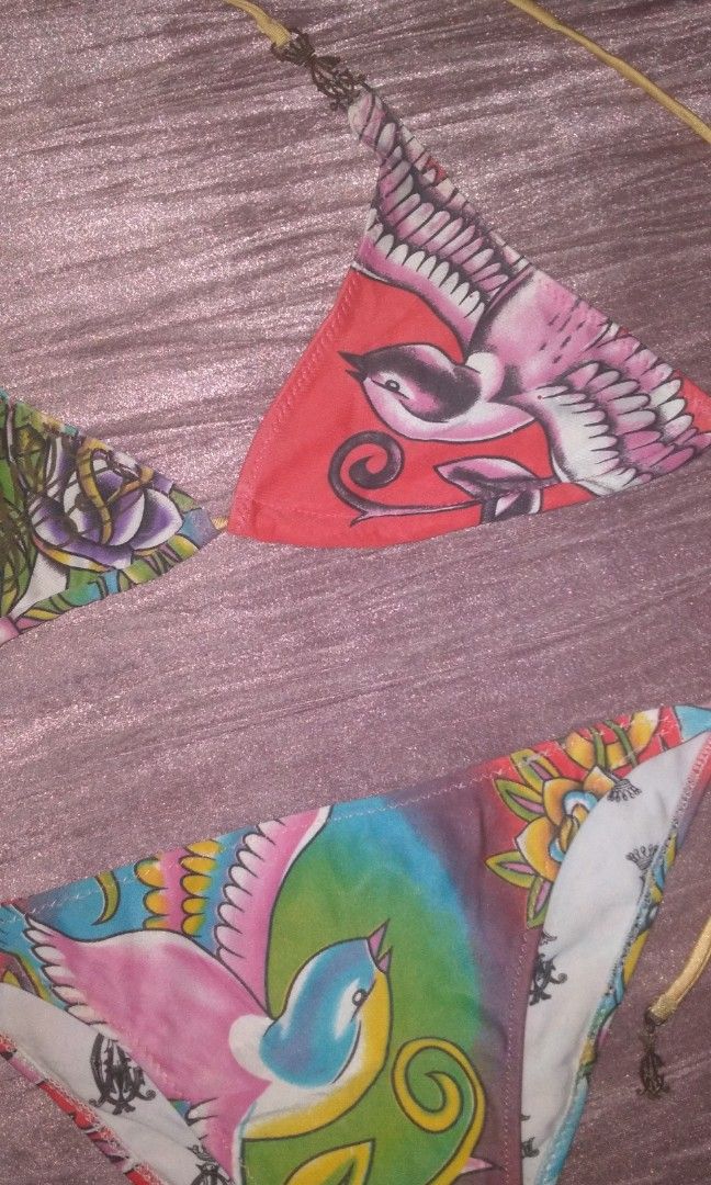 Christian Audigier "Est. 1958" Graphic Bikini Set (Category: Shirts) located in Iloilo. Submitted by ukayedthis (Listing ID 1453351919, Image 2). Description: - Christian Audigier Bikini Set - "Est. 1958" graphic - Colorful tie-dye pattern on one side - Crown motifs - Fabric has a slight sheen - Brand new with tag attached - Perfect statement piece.