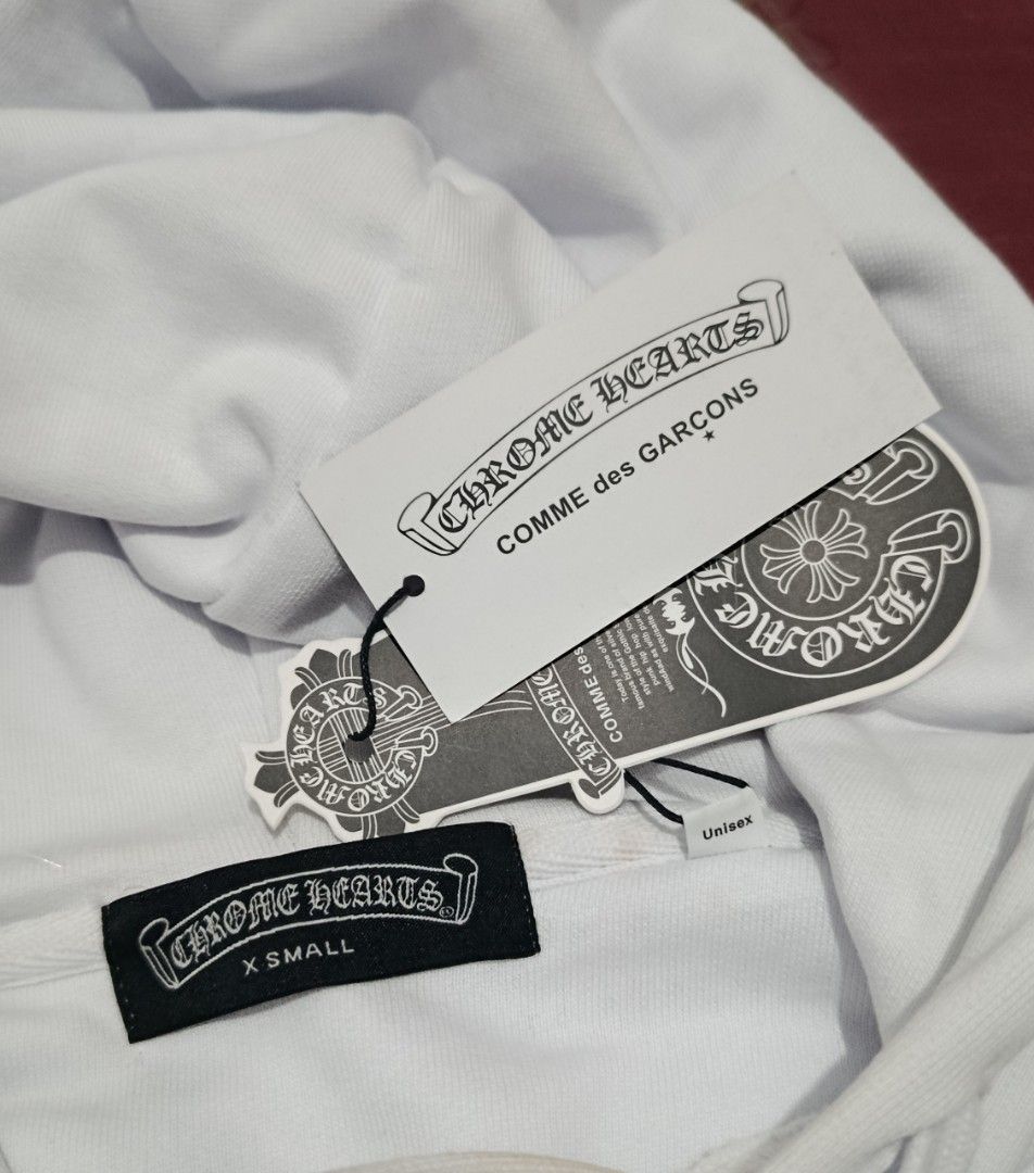 CHROME HEARTS HOODIE (WHITE) (Category: Coats, Jackets and Outerwear) located in Manila. Submitted by __r.sh00 (Listing ID 1453315898, Image 2). Description: Chrome Hearts Hoodie (White) - XS on tag but can fit up to L (since it's loose/baggy type) - unisex - NOT ORIGINAL!!! just guaranteed high qual dupe - never been used (impulsive buy) - bought for the same price - 9.5/10 condition due to minimal discolorations (check pics) MOP: gcash, secuban