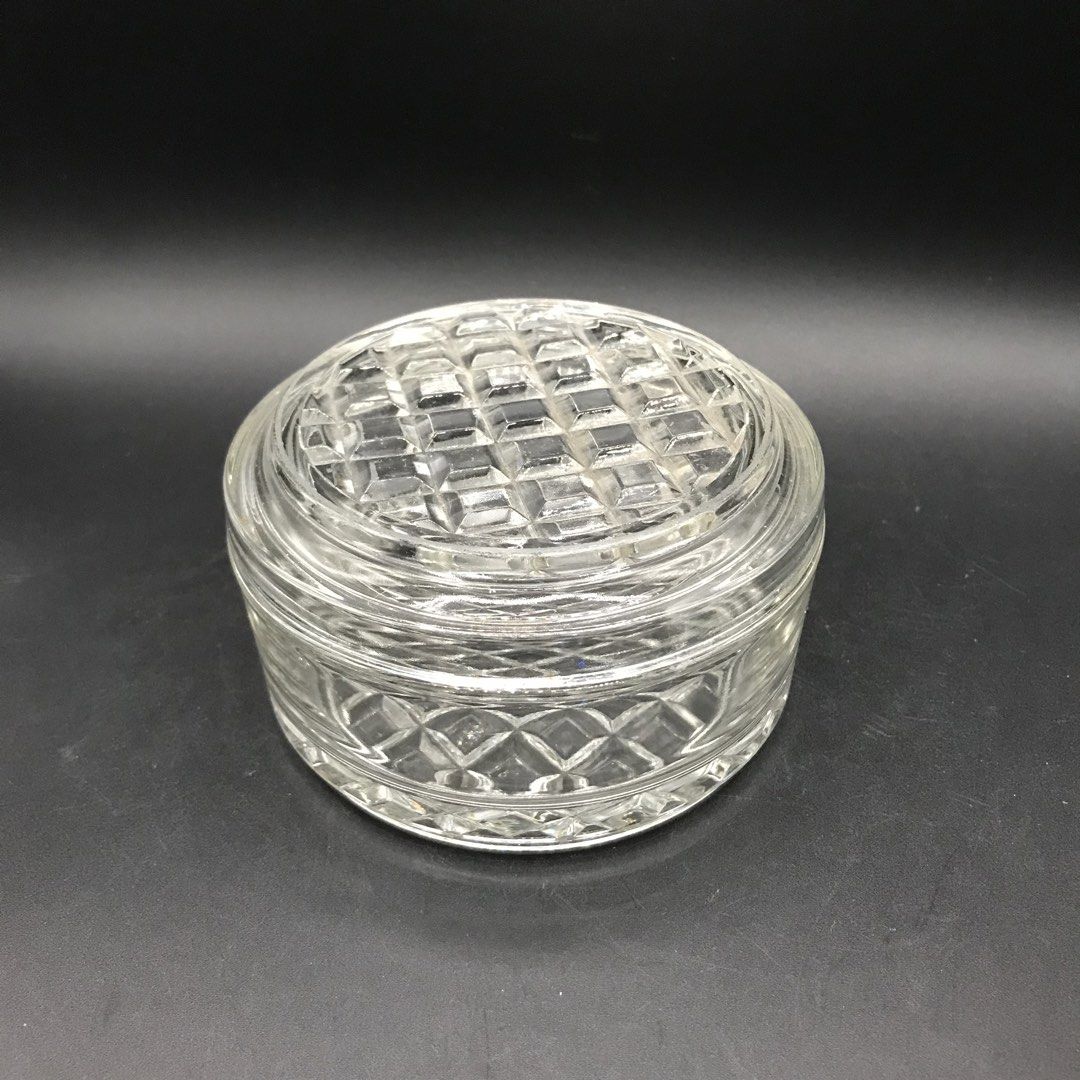 Clear Glass Round Container with Lid (Category: Food Organization & Storage) located in Baao. Submitted by all.things.japan (Listing ID 1453401539, Image 2). Description: 4.25 x 2.5 inches - Vintage clear glass round container with matching lid. - Features a beautiful diamond and grid pattern on the base and lid. - Ideal for storing small trinkets, jewelry, or as a charming decorative accent. - Adds a touch of retro elegance to any space..