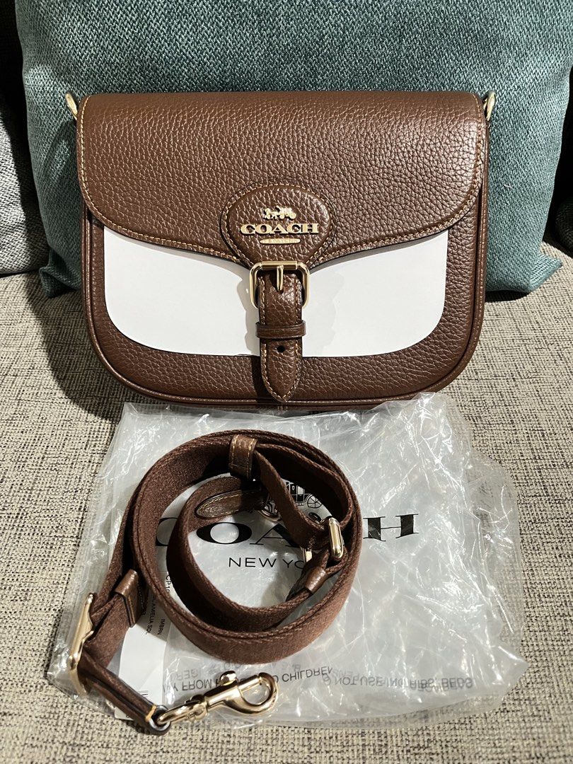 Coach Amelia Saddle Bag Brown/Redwood (Category: Luxury Bags & Wallets) located in Caloocan City. Submitted by kcdiliman (Listing ID 1453278421, Image 3). Description: - Authentic Coach Amelia Saddle Bag - Color: Brown/Redwood with white accent - Adjustable strap for versatile wear - Multiple interior compartments for organization - Recently purchased - Unused.