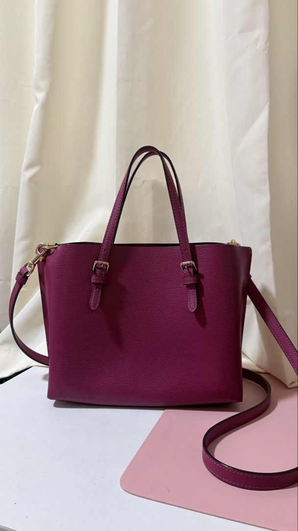 Coach Pebble Leather Tote Bag with Shoulder Strap (Category: Luxury Bags & Wallets) located in Iba. Submitted by fruitypebblezz (Listing ID 1453295234, Image 2). Description: - Coach pebble leather tote bag - Deep berry color - Top handles - Detachable shoulder strap - Zip-top main compartment - Interior zippered pocket - Minor wear on interior zipper trim - Perfect for everyday use.