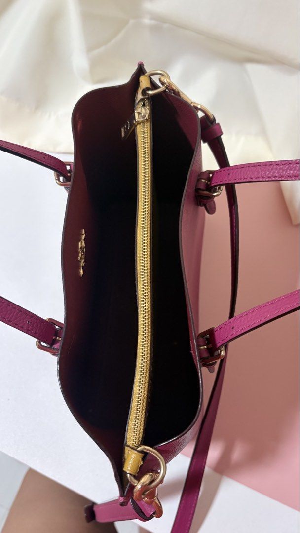 Coach Pebble Leather Tote Bag with Shoulder Strap (Category: Luxury Bags & Wallets) located in Iba. Submitted by fruitypebblezz (Listing ID 1453295234, Image 3). Description: - Coach pebble leather tote bag - Deep berry color - Top handles - Detachable shoulder strap - Zip-top main compartment - Interior zippered pocket - Minor wear on interior zipper trim - Perfect for everyday use.