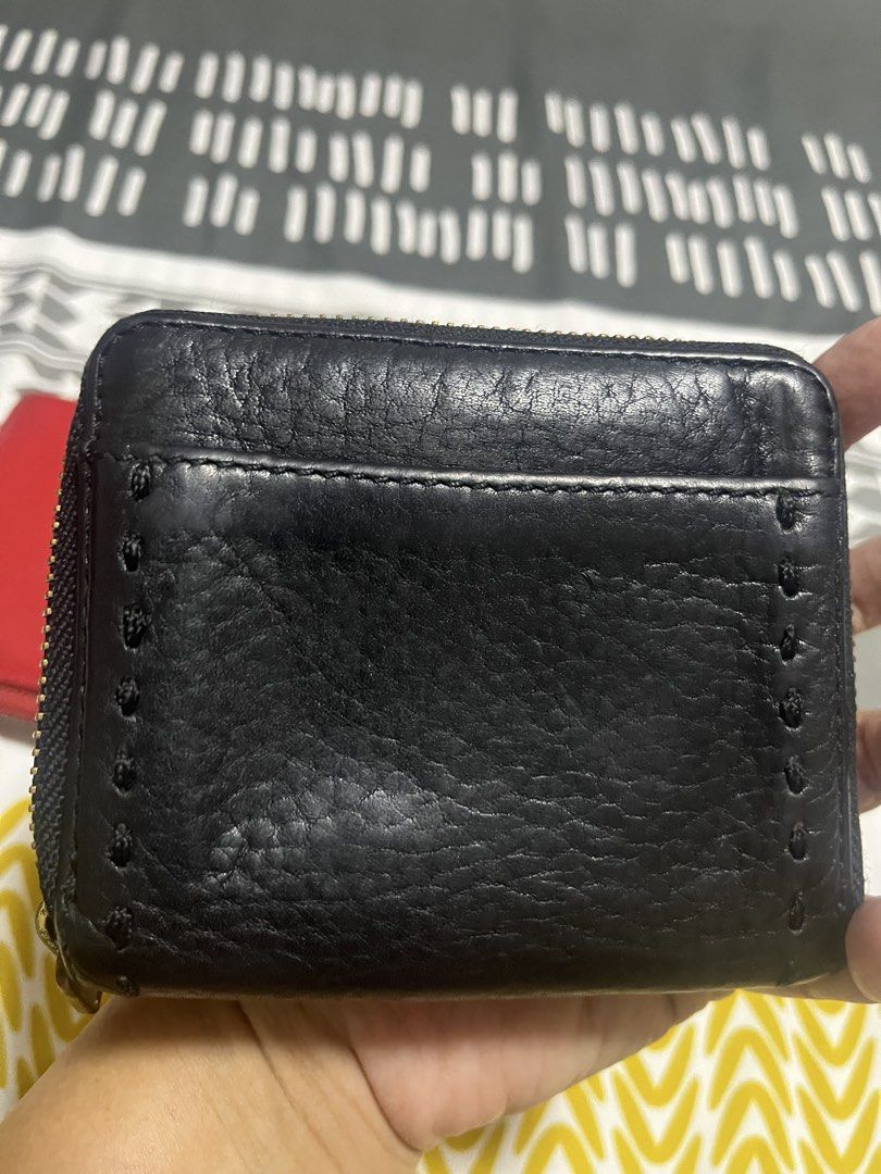 Cole Haan Black Leather Zip Around Wallet (Category: Wallets & Card holders) located in Manila. Submitted by yangcastro47434 (Listing ID 1453314735, Image 2). Description: - Brand: Cole Haan - Material: Black Leather - Closure: Zip Around - Hardware: Gold - Exterior: Textured leather with decorative stitching - Size: Compact, fits easily in pockets/small bags - Functionality: Ideal for cards and cash.