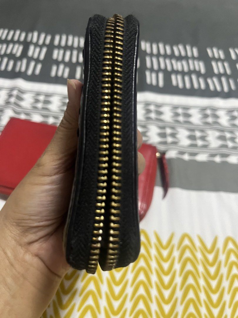 Cole Haan Black Leather Zip Around Wallet (Category: Wallets & Card holders) located in Manila. Submitted by yangcastro47434 (Listing ID 1453314735, Image 3). Description: - Brand: Cole Haan - Material: Black Leather - Closure: Zip Around - Hardware: Gold - Exterior: Textured leather with decorative stitching - Size: Compact, fits easily in pockets/small bags - Functionality: Ideal for cards and cash.