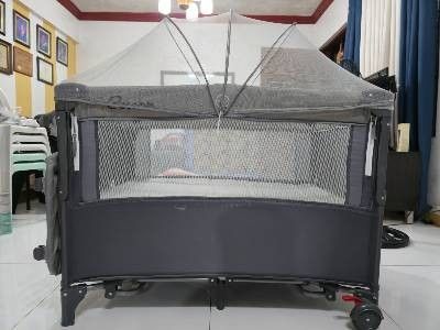 Crib for baby (Category: Cots & Cribs) located in Makati City. Submitted by michellnoz50229 (Listing ID 1453239165, Image 3). Description: Cocobb Baby Crib Standard size (100 x 74 x 70 cm) With Mosquito net Has co-sleeper on one side Color Gray Weight Capacity: - Layer 1 (Crib/Bed): 0 to 36 months - Layer 2 (Bassinet/Playpen): 0 to 6 years (varies by height) Materials: Heavy-duty steel support structure, reinforced oxford cloth, and transparent, 