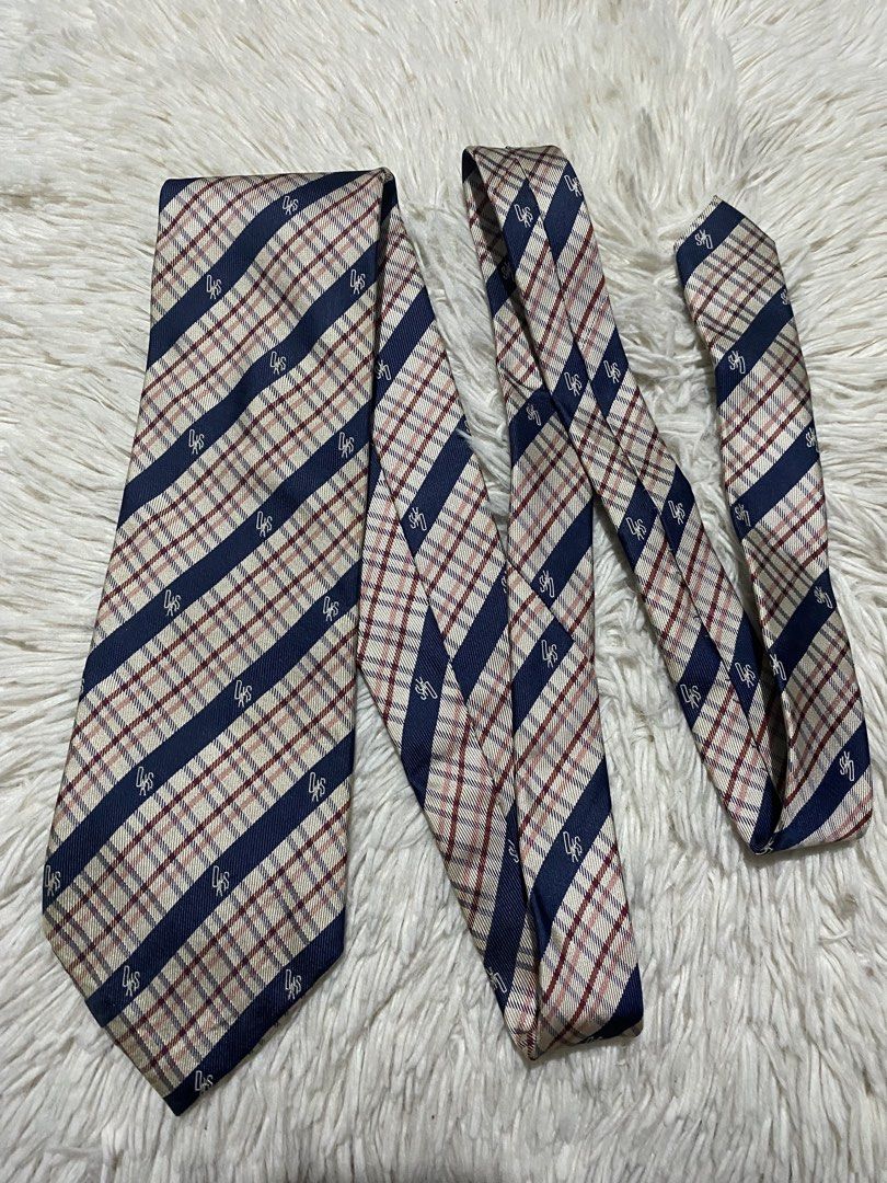 DAKS London Striped Plaid Silk Tie (Category: Ties) located in Bulacan. Submitted by rich2545 (Listing ID 1453333025, Image 1). Description: - Classic DAKS London tie - Color: Navy blue stripe with red plaid pattern - Material: 100% Silk - Features a subtle DAKS logo pattern throughout - Ideal for formal or business occasions - Adds sophistication to any outfit.