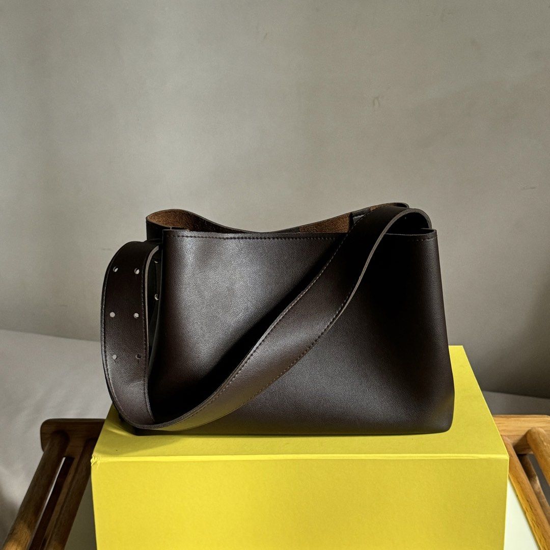 Dark Brown Leather Bucket Bag with Adjustable Strap (Category: Shoulder Bags) located in Davao. Submitted by piscestingz (Listing ID 1453411266, Image 1). Description: - Dark brown leather bucket bag - Adjustable strap with stud details - Lighter brown interior - Simple and chic design - Great for everyday use Rfs: decluttering 💕.