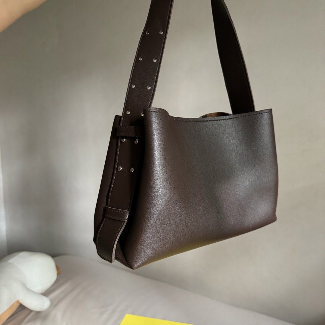 Dark Brown Leather Bucket Bag with Adjustable Strap (Category: Shoulder Bags) located in Davao. Submitted by piscestingz (Listing ID 1453411266, Image 3). Description: - Dark brown leather bucket bag - Adjustable strap with stud details - Lighter brown interior - Simple and chic design - Great for everyday use Rfs: decluttering 💕.