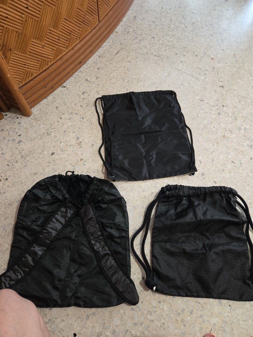 Drawstring bag (Category: Backpacks) located in Singapore. Submitted by feriabeauty (Listing ID 1453328440, Image 2). Description: - Set of 3 drawstring bags - Includes: 1 white 'cuegolf.com' bag, 1 black 'RSF' bag, 1 black 'SIT' bag - Versatile for gym, travel, or daily use - All in good, pre-loved condition - one for $3, get all 3 at $6..