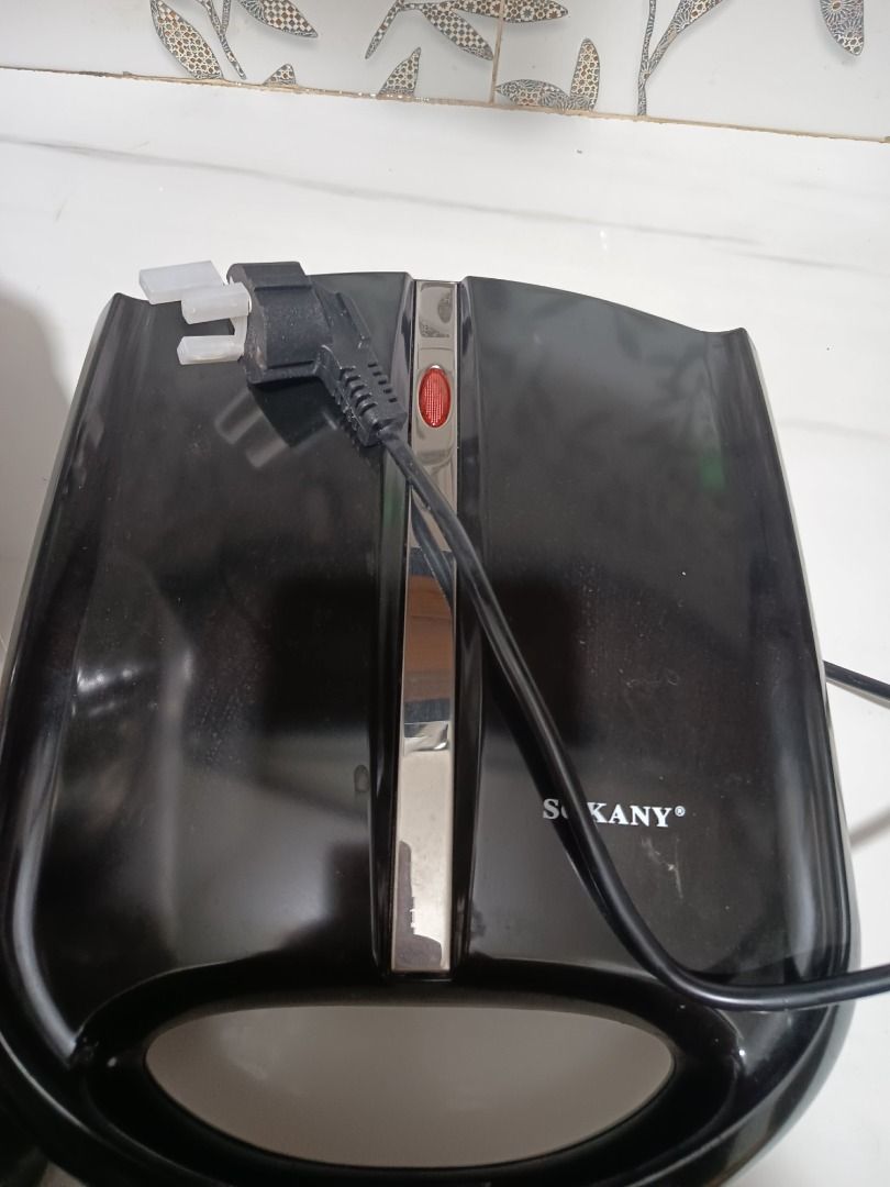 Electric Donut Maker Machine (Category: Other Kitchen Appliances) located in Pasig City. Submitted by ta.ccc (Listing ID 1453393268, Image 2). Description: - Effortlessly make mini donuts at home with this electric donut maker. - Features 24 non-stick molds for easy donut release and quick cleaning. - Simple to use: just pour batter and let it cook. - Ideal for parties, gatherings, or a fun baking activity with kids. - Compact design for convenie