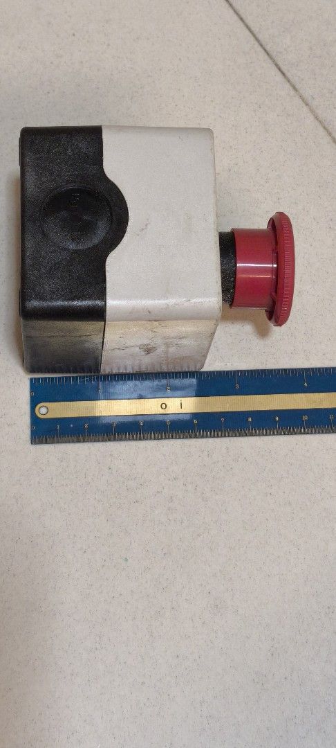 E-STOP BUTTON for machine (Category: Parts & Accessories) located in Singapore. Submitted by wholesomely (Listing ID 1453398710, Image 2). Description: - Emergency Stop Button - Features a prominent red mushroom-shaped push button - Clearly marked with 'EMERGENCY STOP' text and circular arrows - Mounted on a robust grey and black casing - Suitable for industrial or workshop safety applications.