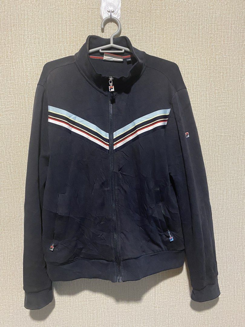 Fila Modern Heritage Navy Track Jacket Size L (Category: Coats, Jackets and Outerwear) located in Manila. Submitted by cdb_22 (Listing ID 1453423585, Image 2). Description: - Navy blue Fila track jacket - Size L - Classic Fila logo on chest and sleeve - White, red, and blue chevron stripe detail across chest - Full zip closure - Includes pockets.