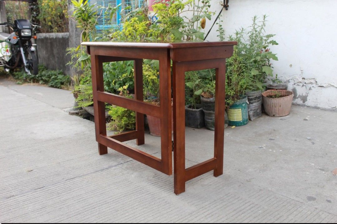 Folding Table (Category: Tables & Sets) located in Meycauayan. Submitted by marygracecasimiro (Listing ID 1453384725, Image 1). Description: Solid Wood Folding Desk Side panels that fold inward and a flip-down top shelf for easy storage and space-saving use. Made from durable solid wood with a rich reddish-brown finish L:31 ½ • W:17 ¾ • H:27 ¾ inches 3,200 pesos only💛💛.