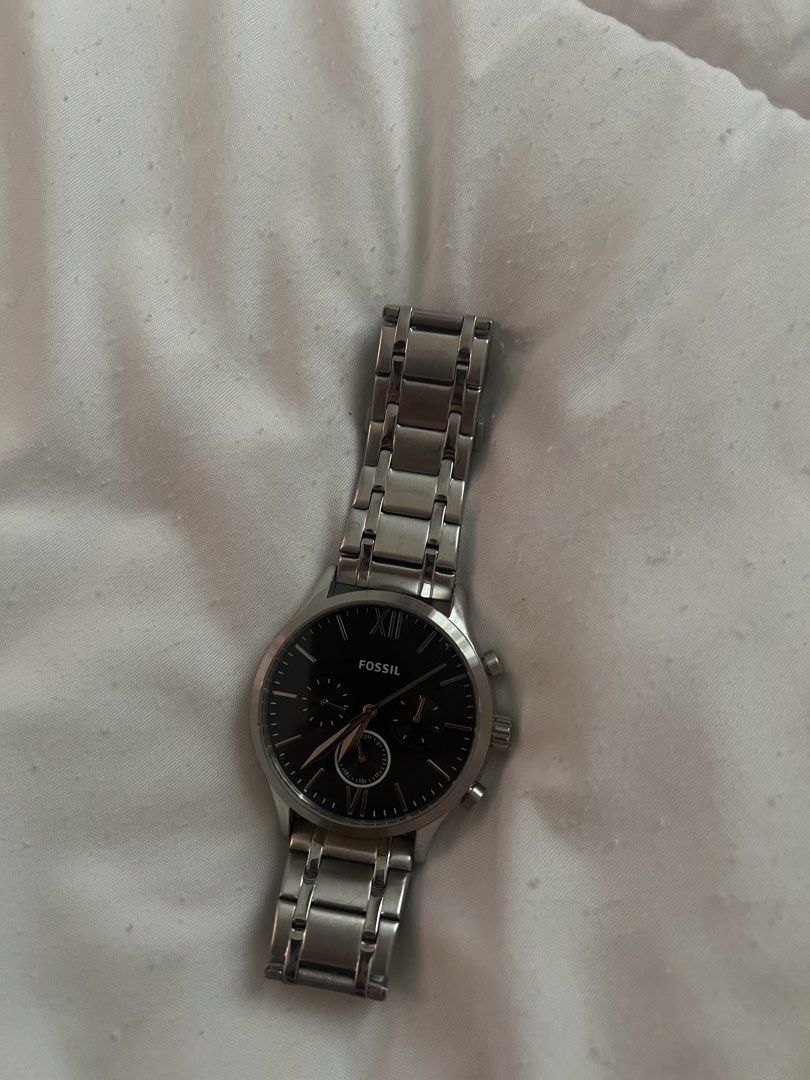 Fossil Men's Stainless Steel Watch (Category: Men's Watches) located in Calamba. Submitted by cdcloset26 (Listing ID 1453335286, Image 1). Description: - Classic Fossil chronograph watch - Black dial - Stainless steel band and casing - Features sub-dials for chronograph function - Roman numeral at the 12 o'clock position - Water resistant - Versatile for both casual and formal wear.