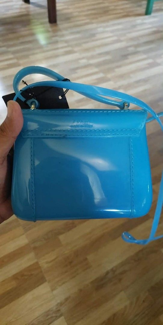 Furla Jelly Mini Bag - Blue (Category: Luxury Bags & Wallets) located in Bay. Submitted by silverhorse-59c851 (Listing ID 1453272699, Image 2). Description: - Cute blue Furla mini jelly bag - Features a gold clasp closure - Includes a detachable strap - Made in Italy - Ideal for a pop of color - Perfect size for essentials.