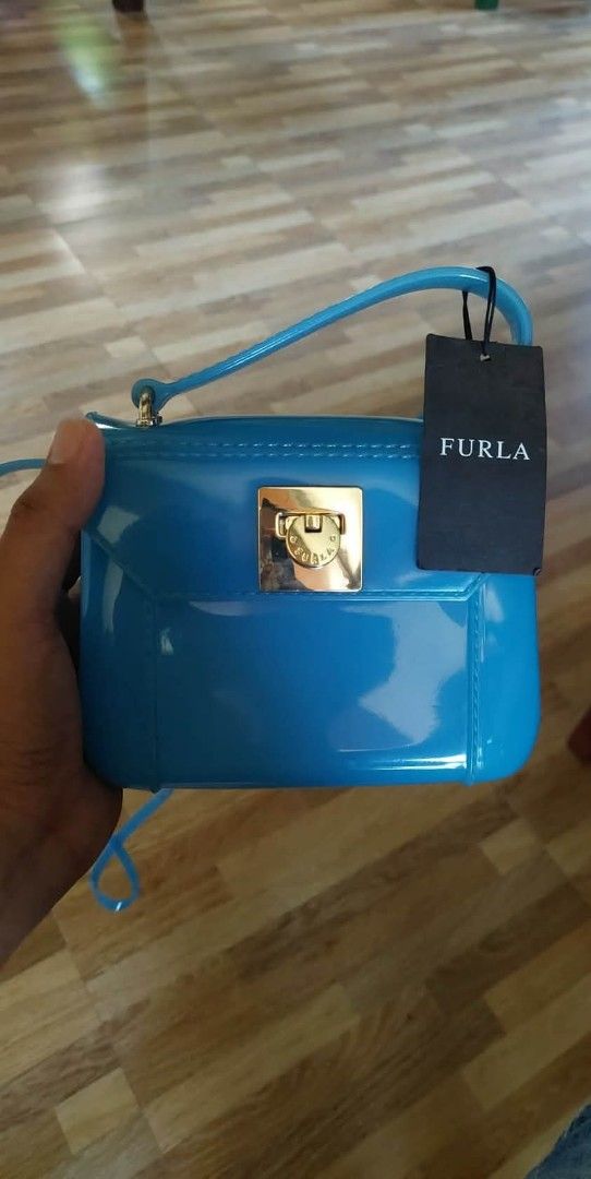 Furla Jelly Mini Bag - Blue (Category: Luxury Bags & Wallets) located in Bay. Submitted by silverhorse-59c851 (Listing ID 1453272699, Image 1). Description: - Cute blue Furla mini jelly bag - Features a gold clasp closure - Includes a detachable strap - Made in Italy - Ideal for a pop of color - Perfect size for essentials.
