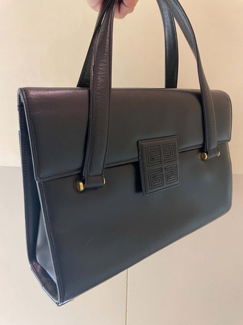 Givenchy Black Leather Handbag (Category: Luxury Bags & Wallets) located in Manila. Submitted by luxblocc (Listing ID 1453269234, Image 2). Description: - Classic black leather handbag - Iconic Givenchy 4G logo clasp - Top handle design - Interior zip pocket - Gold hardware details - Timeless piece for any collection - Great for daily use or special occasions.